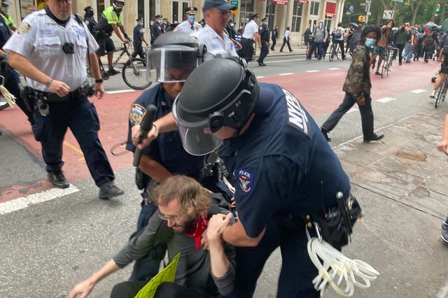 NYPD officers detain a person during an Abolish ICE protest on September 17, 2020.